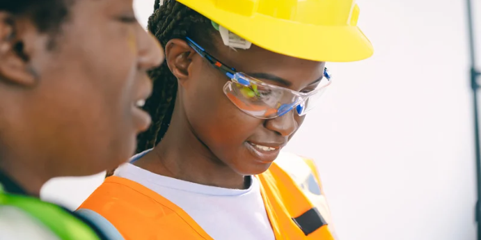 oil rig workers following hse measures wearing ppe, protective glasses and hard hats