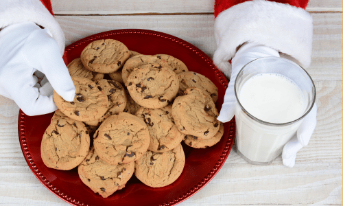 Santa claus cookies and milk on a red plate