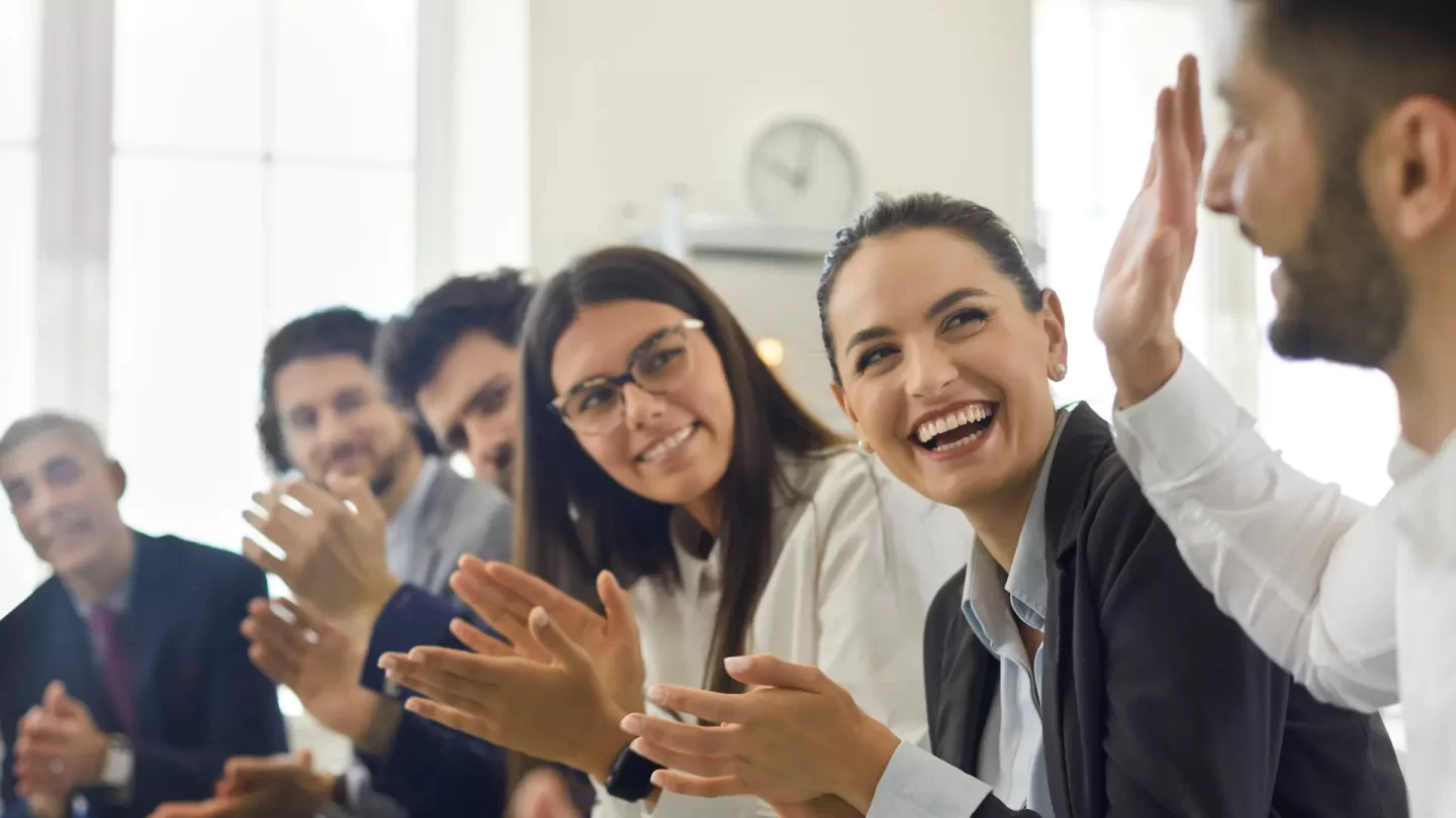 person being clapped at at work for achievements