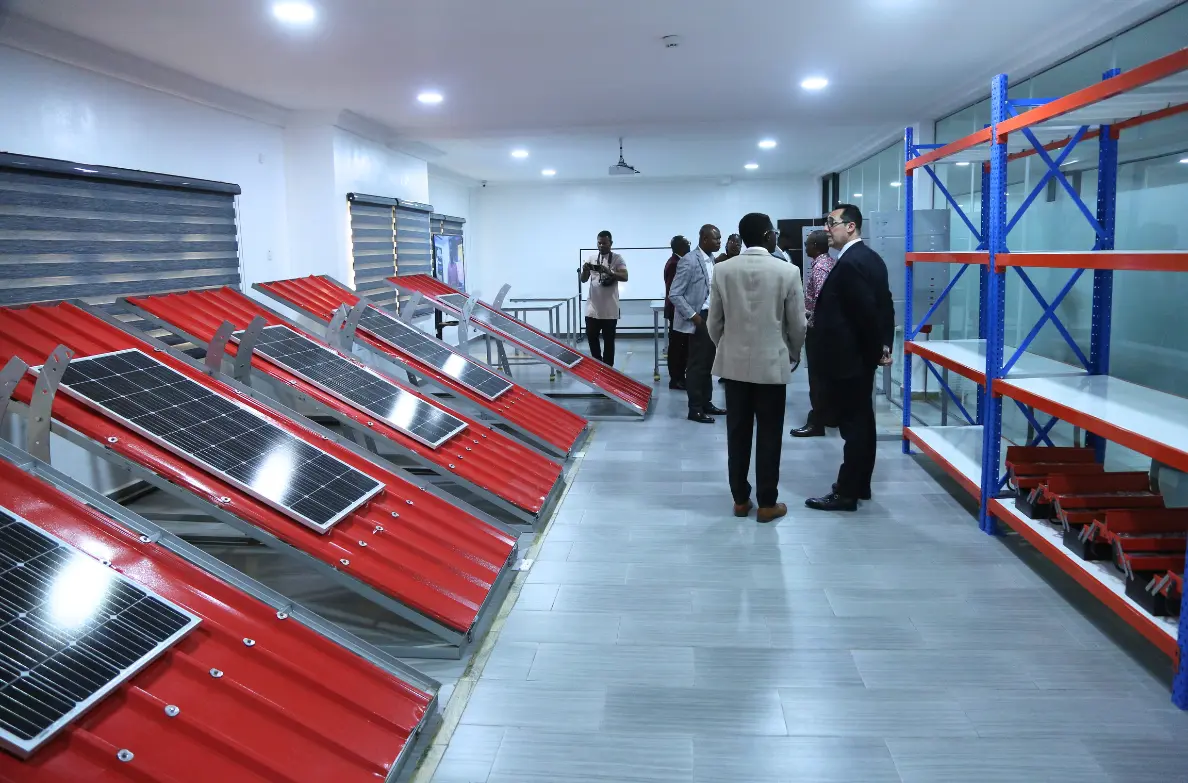 group of people discussing training services at a training facility surrounded by solar panels