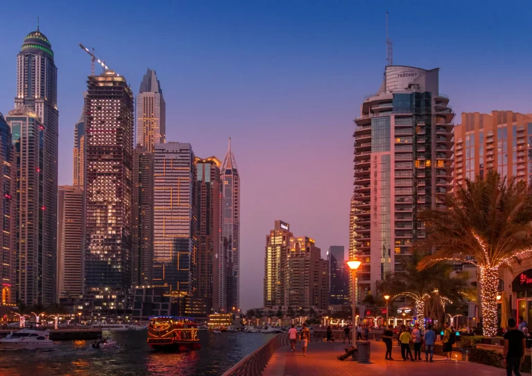 A stunning evening view of Dubai Marina with illuminated skyscrapers and a vibrant waterfront, reflecting the dynamic opportunities in recruitment services in the UAE