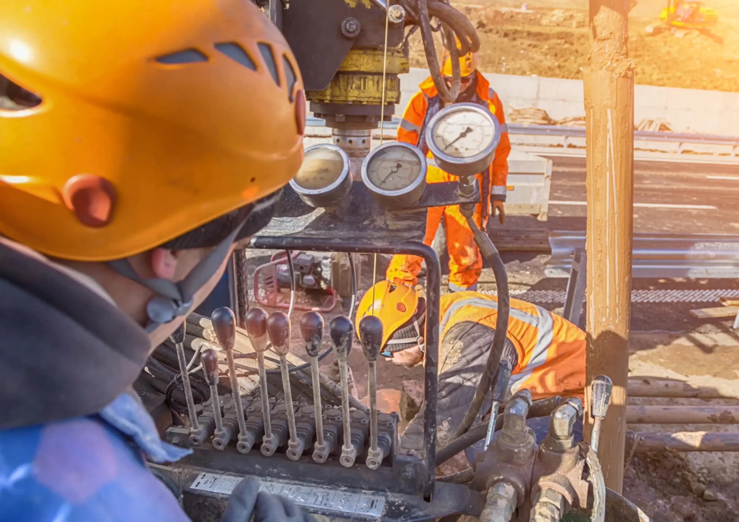 Engineers operating drilling equipment on a construction site, representing specialized engineering services in Mexico.