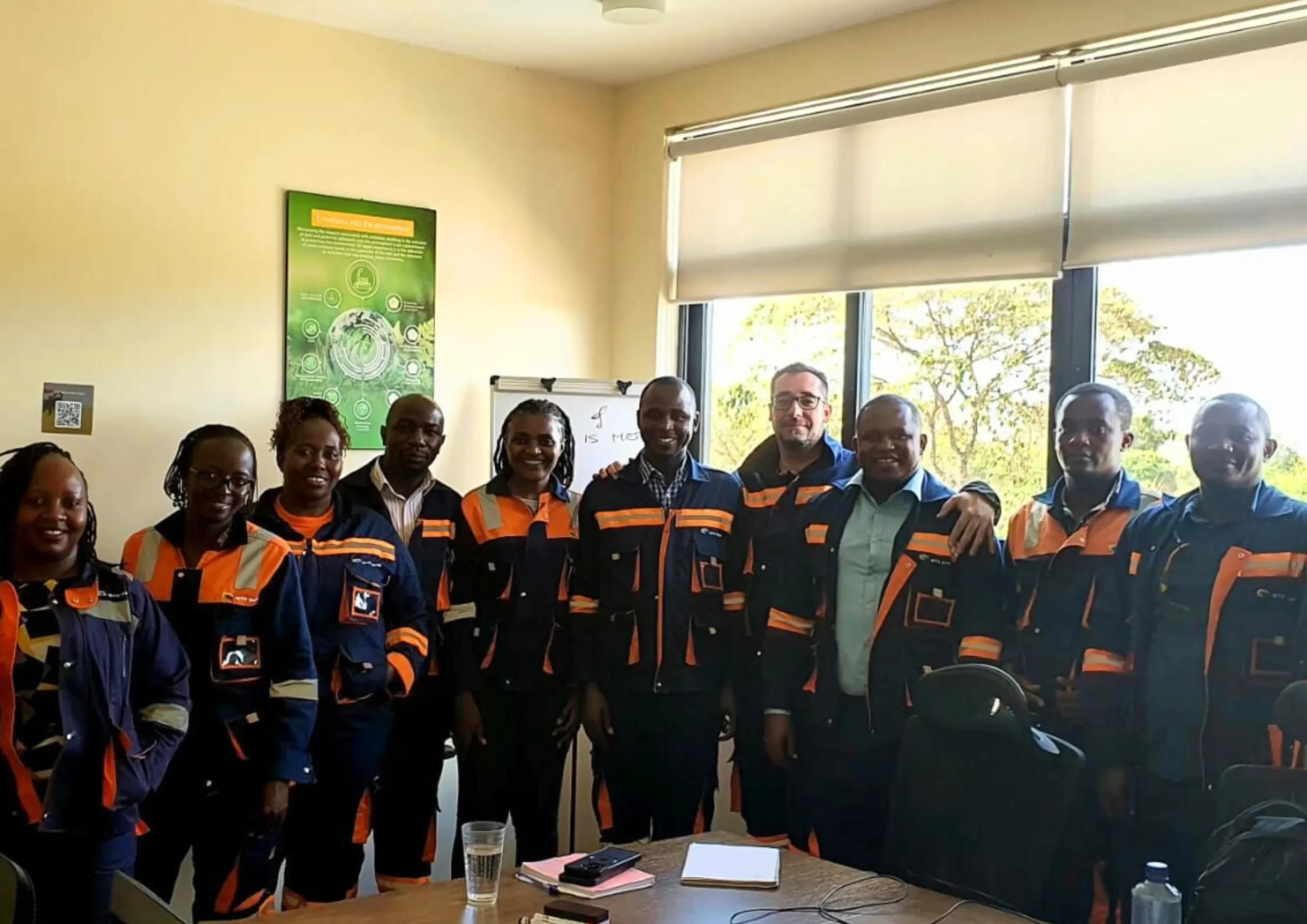 Team of engineers in uniform posing indoors.