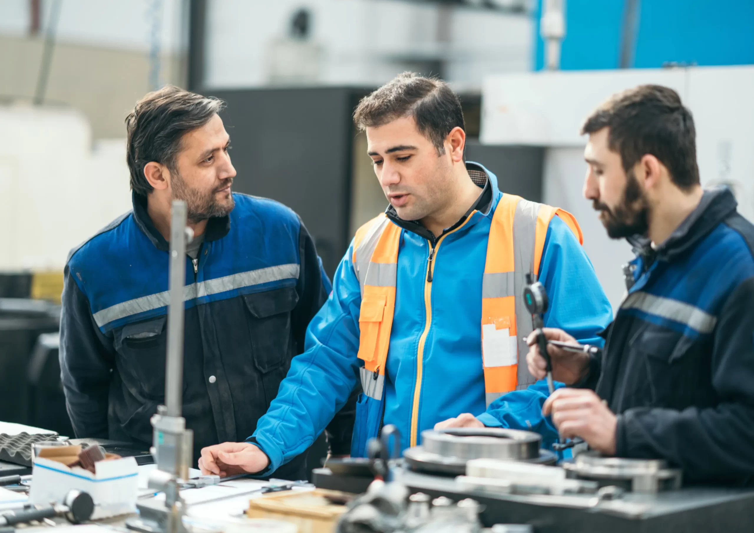 Engineers collaborating on technical plans and inspections as part of O&M services for the offshore and marine industry.