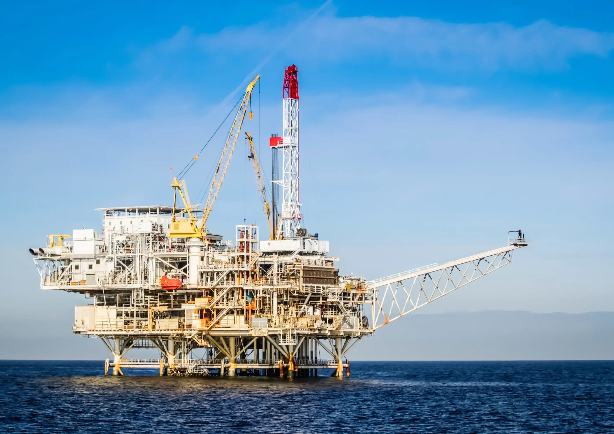 Offshore oil and gas platform supporting operations and maintenance activities in open water.